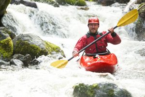Man in a river kayak
