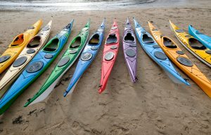 Different Sea Kayaks on a beach