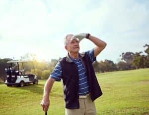 A senior golfer reading the green