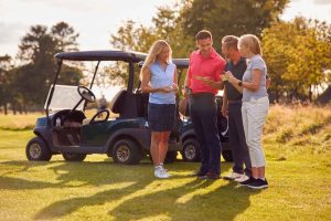 4 people checking score cards