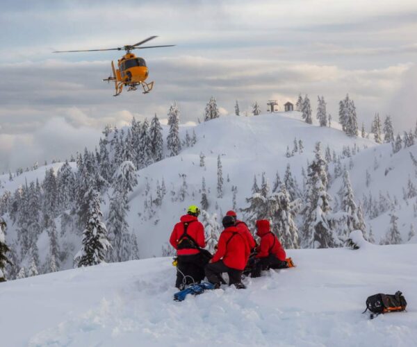 Mountain rescue team on a snowy mountain doing a rescue exercise