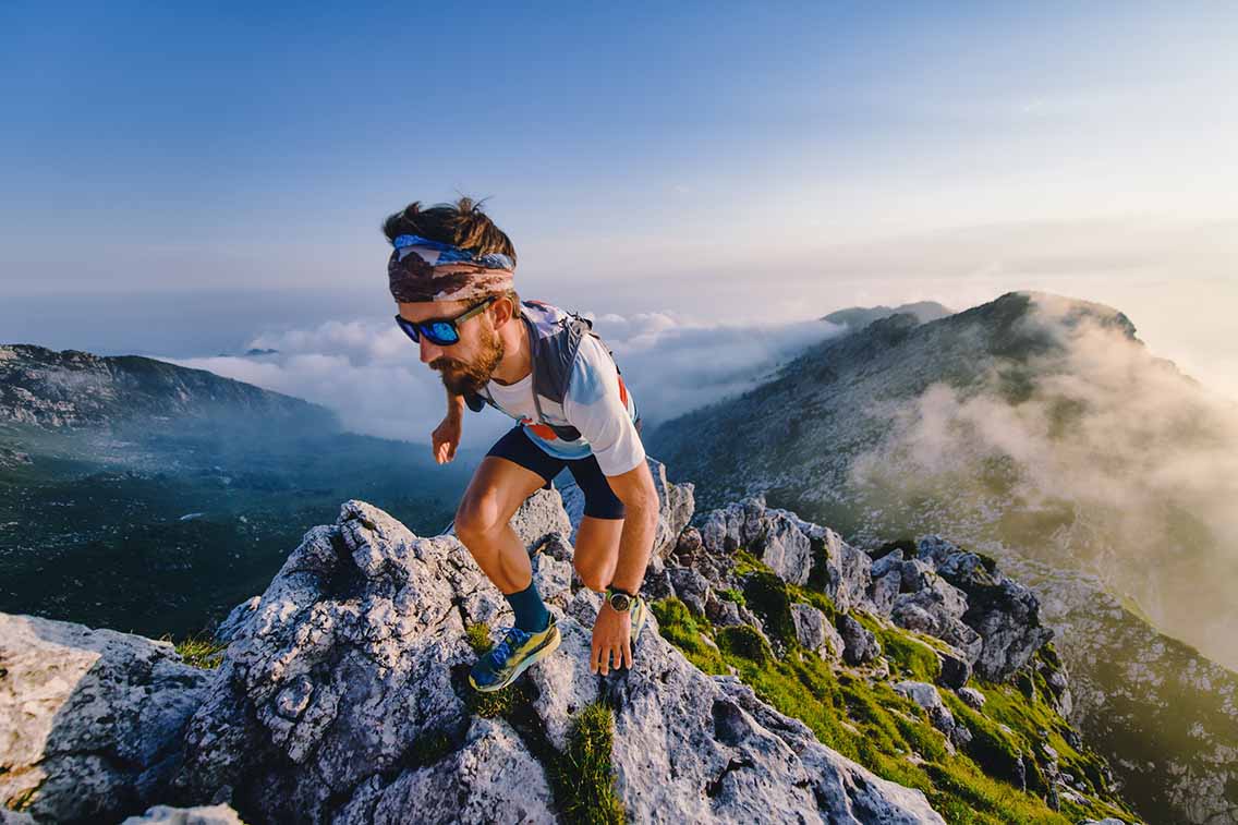 Trail runner at peak of mountain