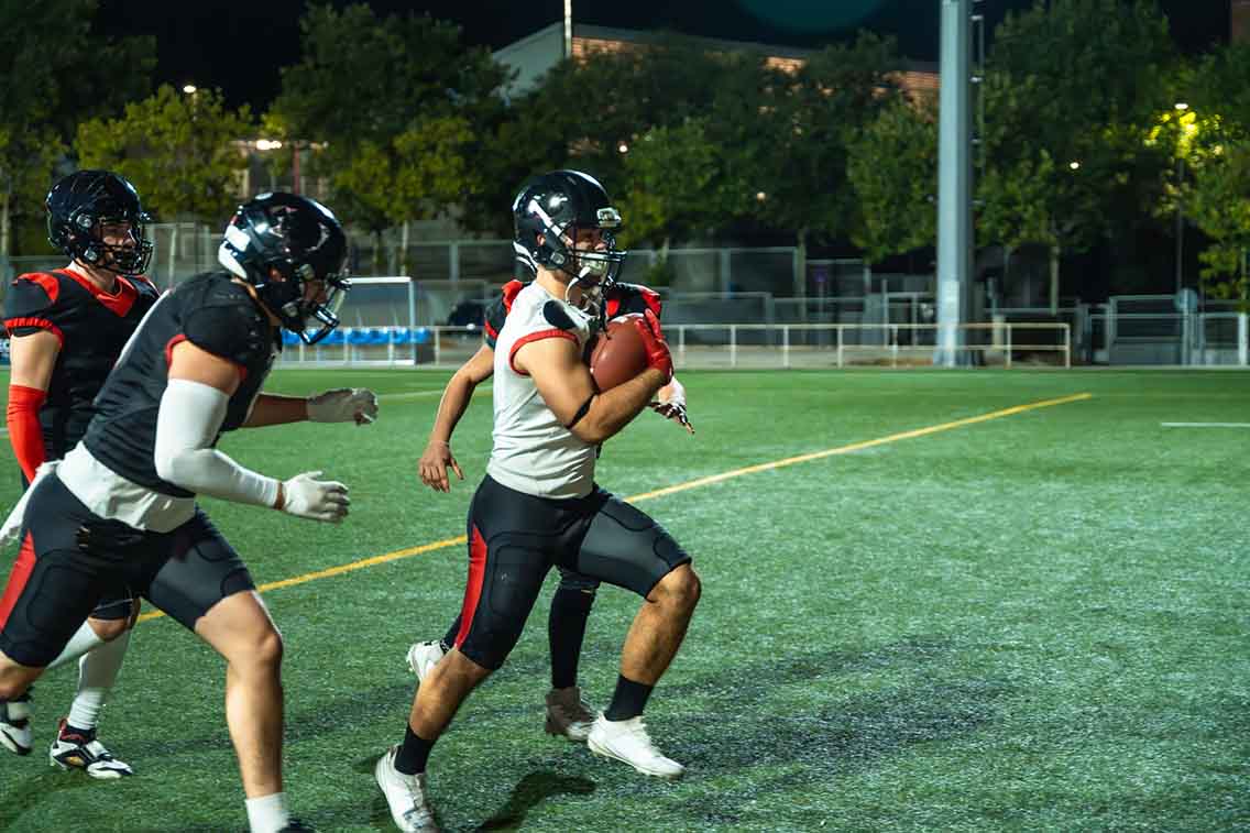 Player running with american football