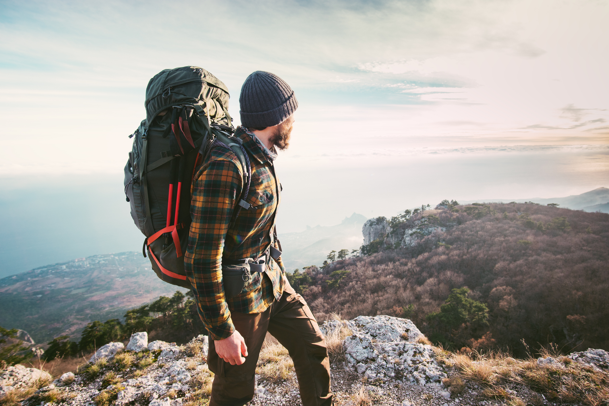 Man with large backpack in mountain terrain