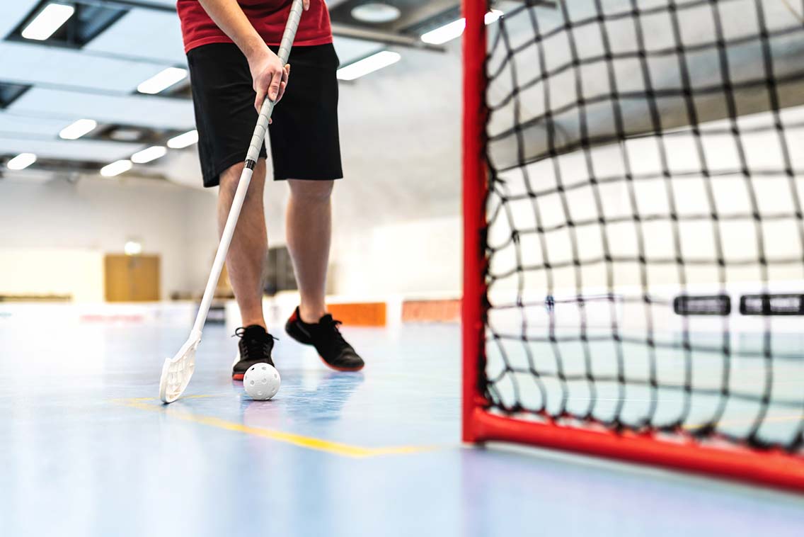 Ball hockey player training on court