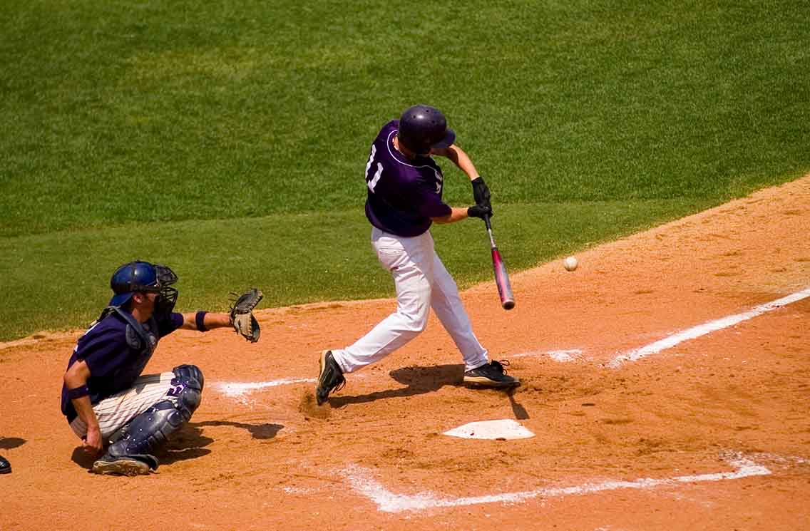 Baseball player hitting ball