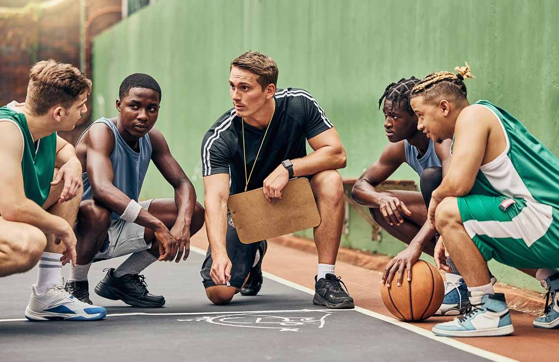 basketball coach talking to students