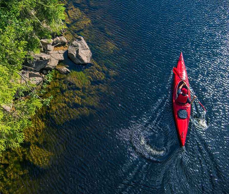Aerial view of red canoe on river