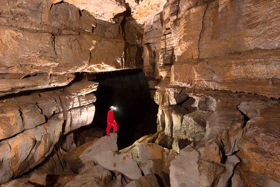 Man in large cave