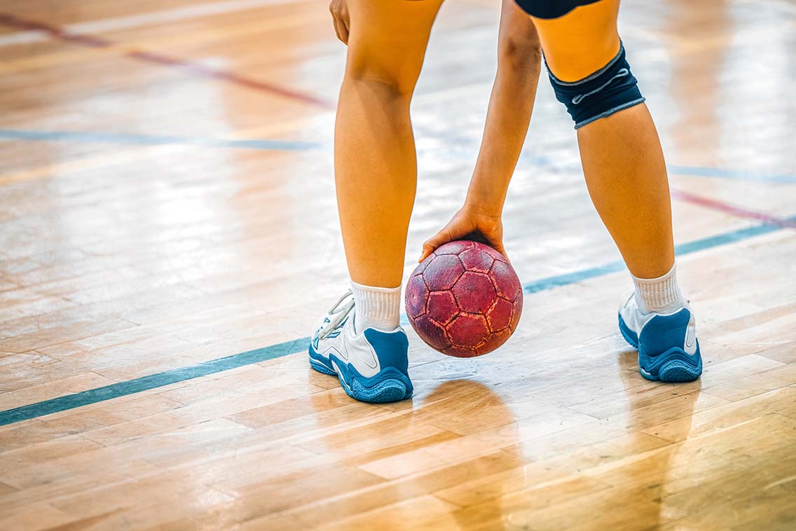 Player touching handball to floor