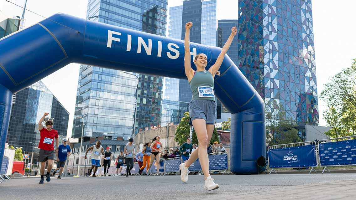 Woman corssing finish line of marathon