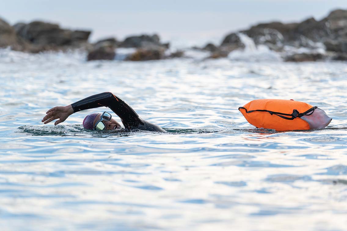 Open water swimmer doing front crawl with tow