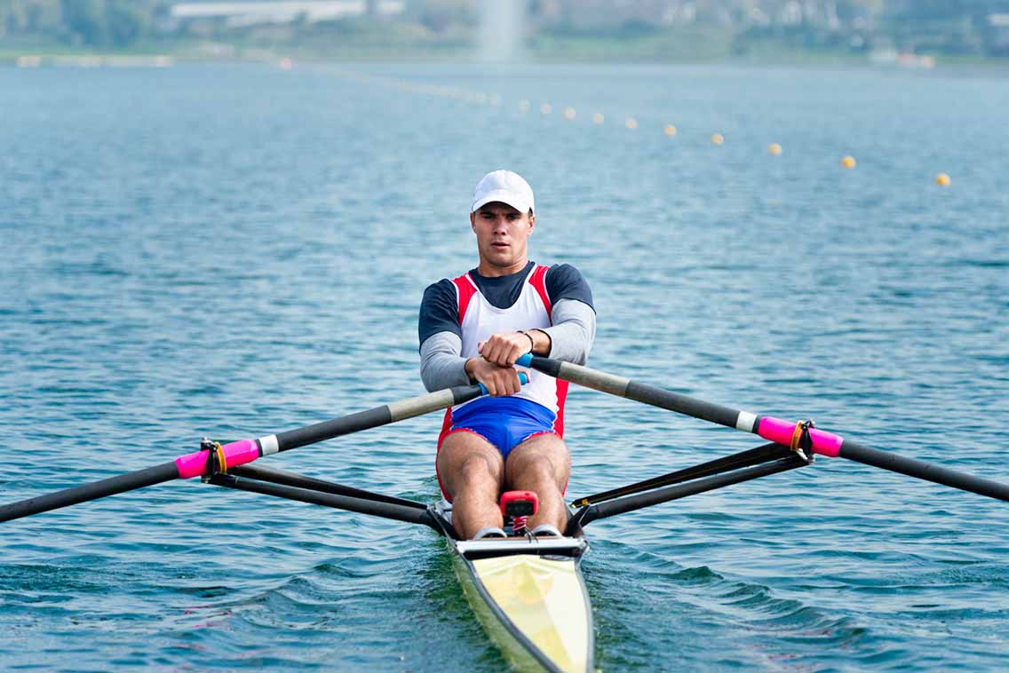 Man sculling on rowing boat