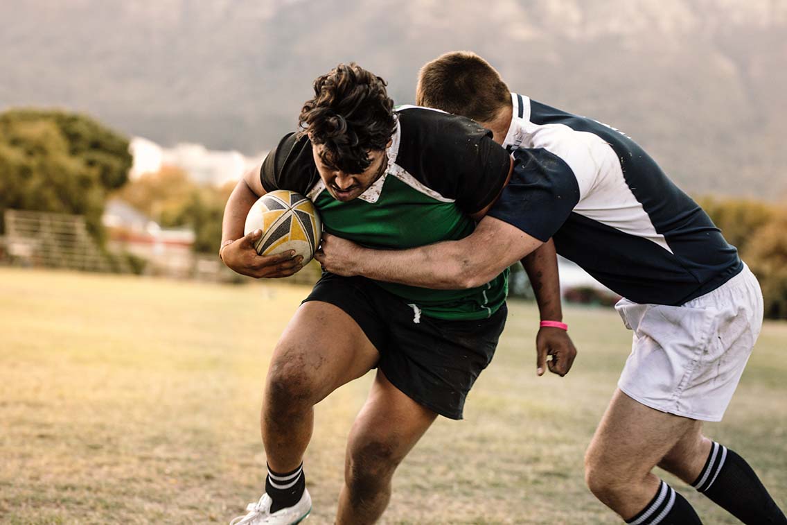 Rugby players in a tackle