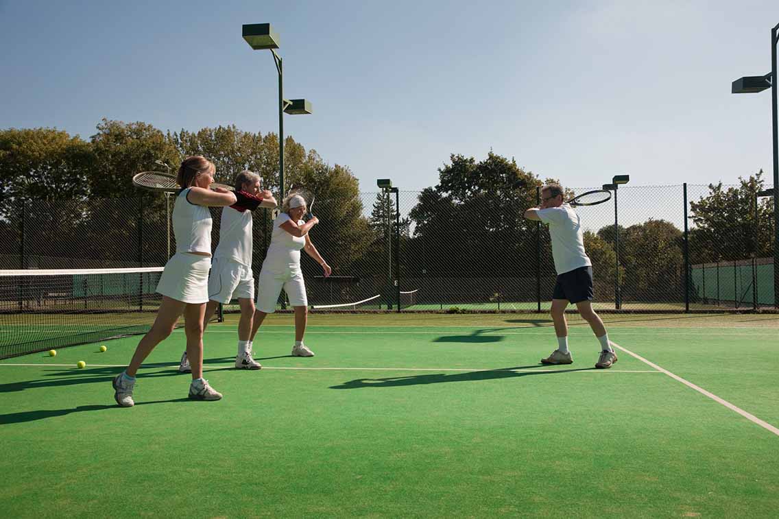Tennis training with coach and club members
