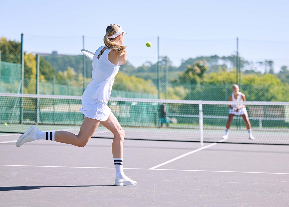 Woman returning tennis shot