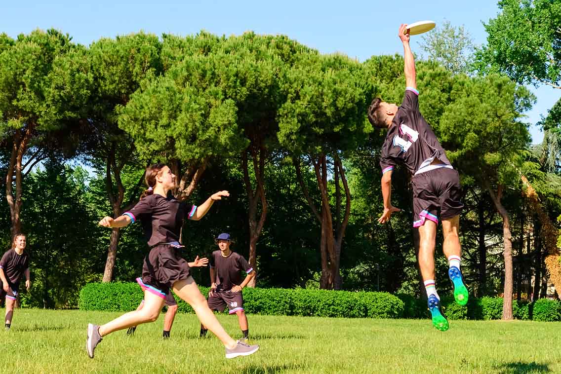 Team playing ultimate frisbee on playing field