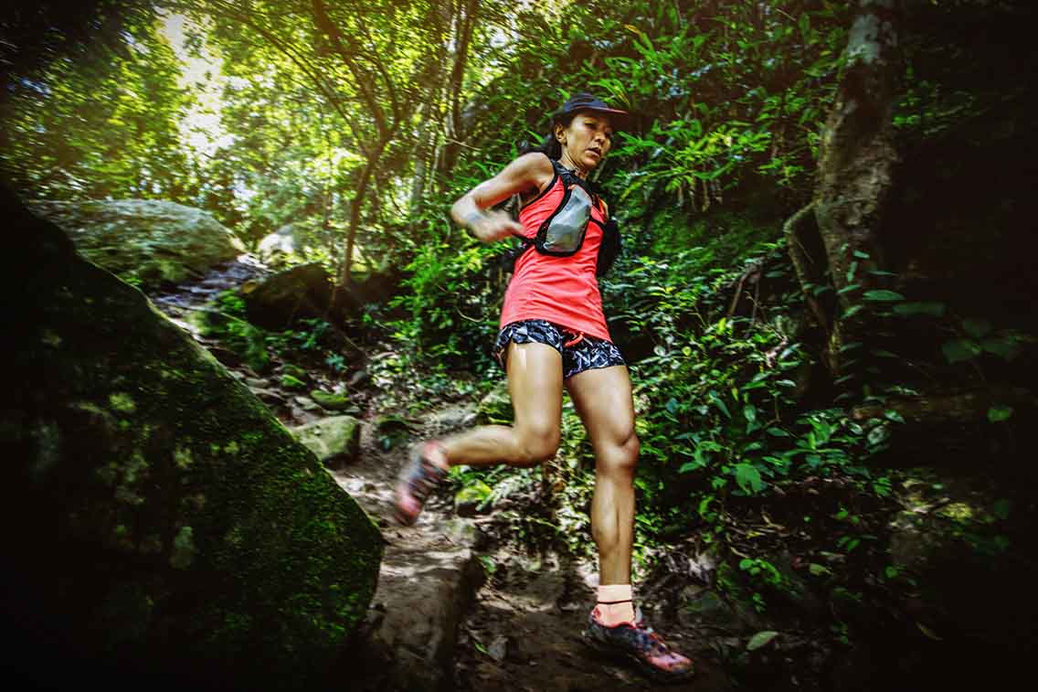 Female trail runner in technical terrain