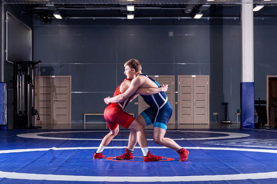 2 wrestlers fighting in arena