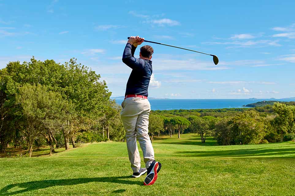 Golfer driving shot on fairway