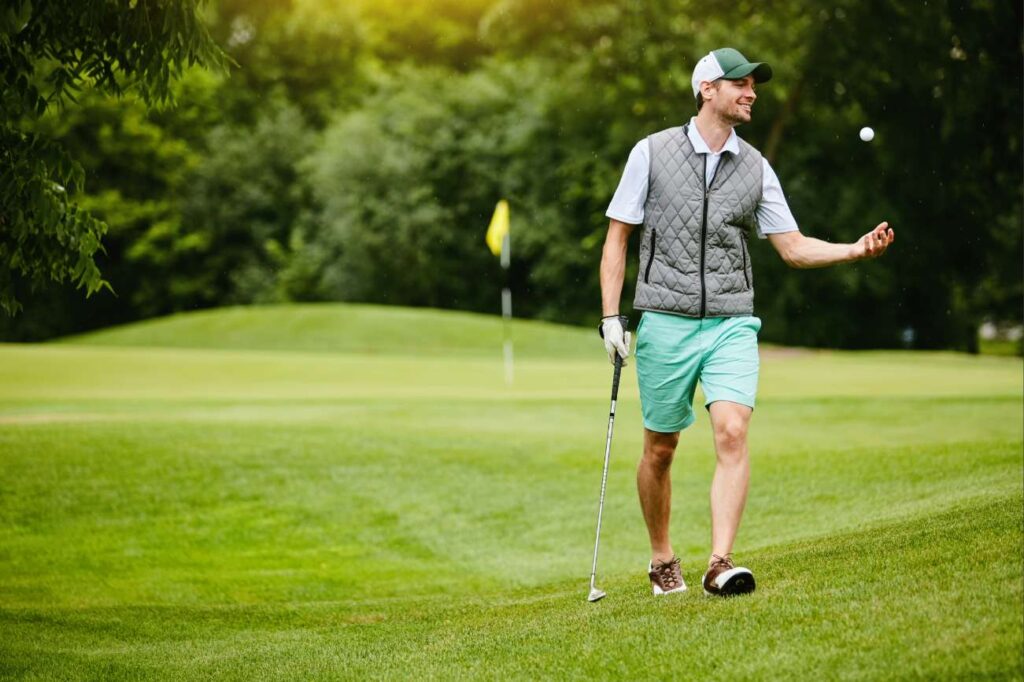 Golfer in casual clothing on green