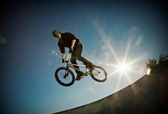 BMX Freestyle Insurance Benefits r BMX rider performing a stunt