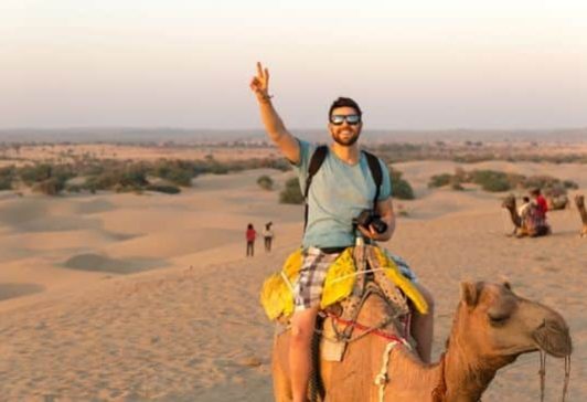 Camel Riding Key Benefits r Tourist riding a camel