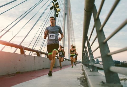 Duathlon runners crossing a bridge