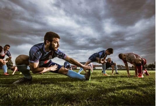 Gaellic footballers stretching before the game