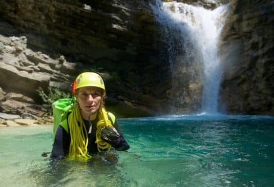 Gorge Walking Insurance – Key Benefits r Woman passing through waterfall