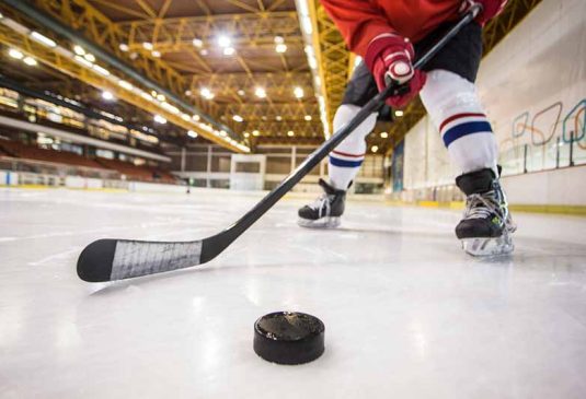 IceHockey-BottomImage Ice hockey stick & puck close-up