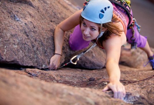 Young woman leading a climbing route