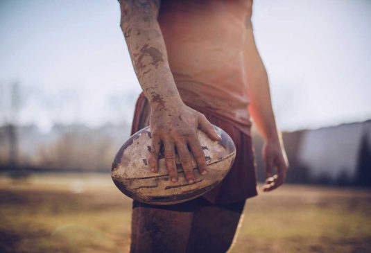 Rugby-BottomImage Rugby player holding ball