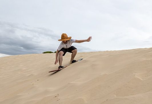 Sandboarder in dunes