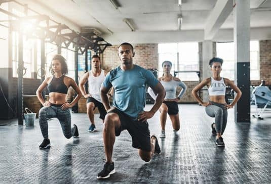Why Gym Work Insurance cr A group of young people doing lunges together