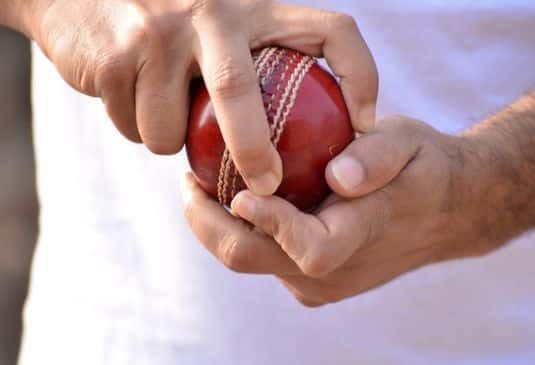 Why Indoor Cricket Insurance cr Cricket player holding a ball