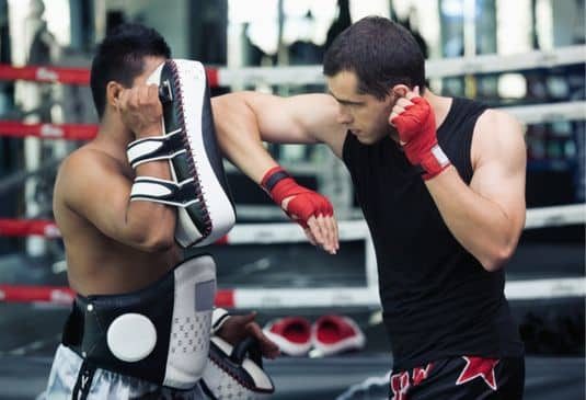 Why Muay Thai Boxing Insurance cr Tow male Muay Thai boxers training