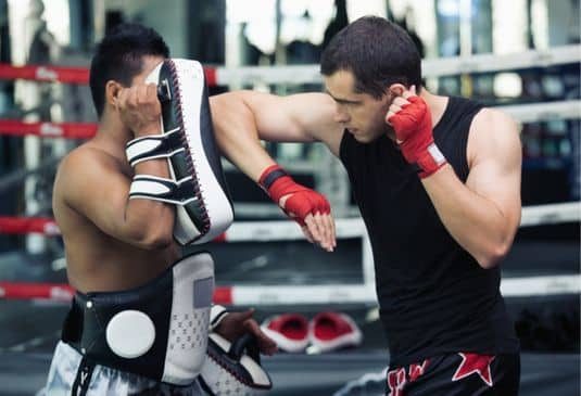 Tow male Muay Thai boxers training