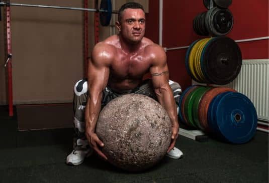 Why Strongman Insurance c Strongman trying to lift a huge rock