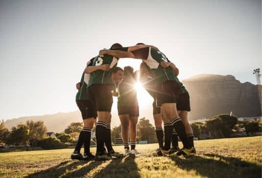 Touch Rugby players standing in a circle