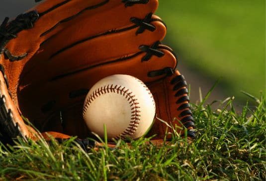 Baseball and glove on the grass