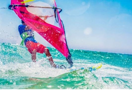 Windsurfer in turquoise water